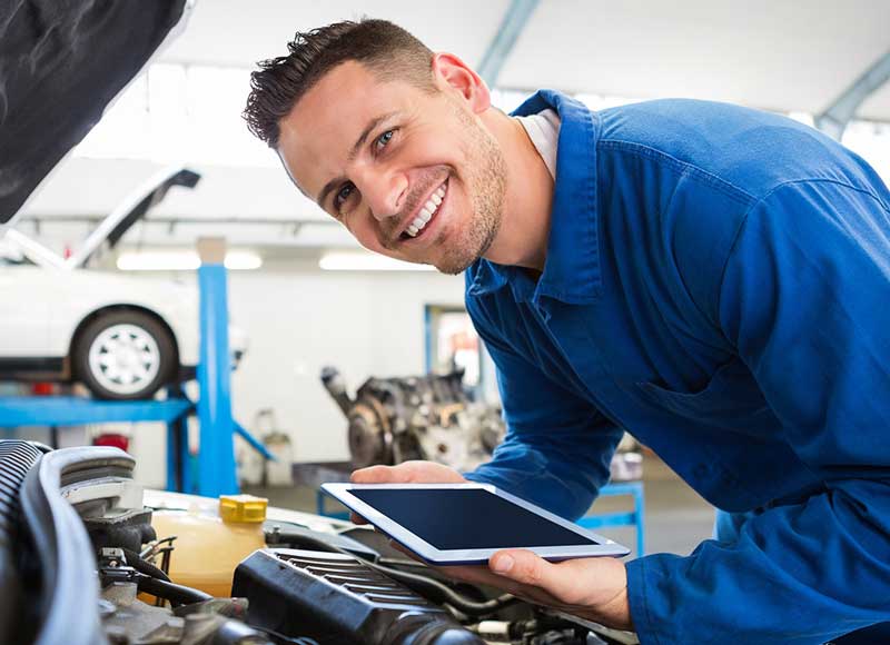Service Technician Checking a Car Engine